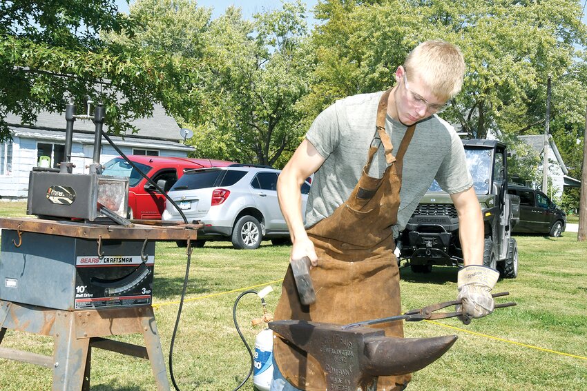 Pictured above, 16-year-old Ashton White of Greenville shows off his blacksmithing skills throughout the festival. White self-taught himself the art of blacksmithing during Covid, and was working on an order of tent stakes.