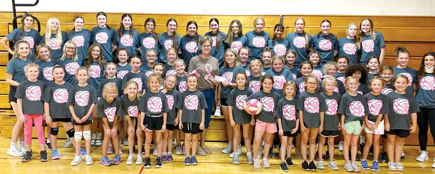 This year's campers and Lincolnwood-Morrisonville volleyball players, led by senior Taryn Millburg, present Tina Haggemeier with a check for more than $800 for the Montgomery County Breast Cancer Support Group from the proceeds of this year's event.