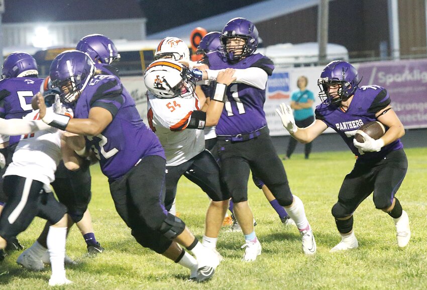 Litchfield's Harrison Thomas (#52) and Carson Saathoff (#11) try to clear out Hillsboro's Elliott Lentz (#54) and the other Topper defenders to give A.J. Sypherd some running room on Friday, Sept. 22. Sypherd had Litchfield's only touchdown, but that and a Cooper Martin field goal were enough as the Panthers scored a 9-7 win on homecoming.