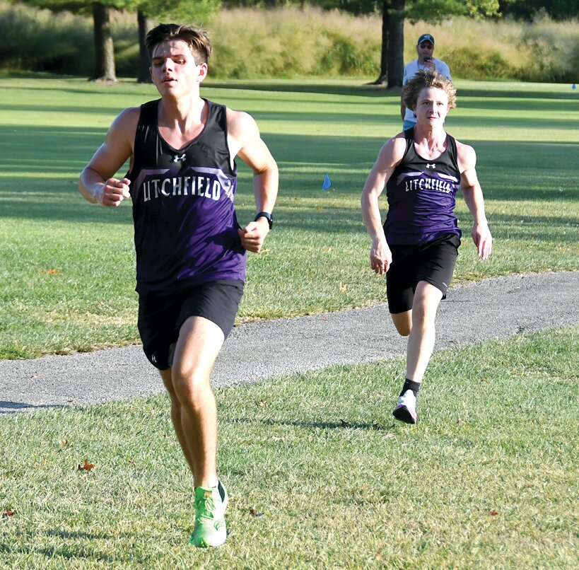 Litchfield's Braxton Kieffer (right) tries to track down teammate Mitchell Floyd (left) at the finished line of the Panthers' home meet on Tuesday, Sept. 26. Floyd finish just before his teammate, clocking in at 19:40 to Kieffer's 19:41.