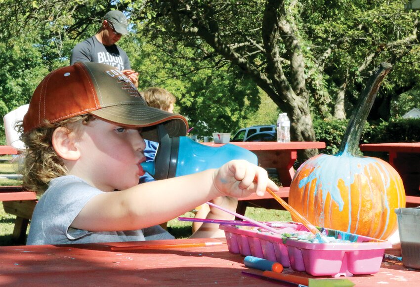 Three-year-old Layton Gross enjoys making his pumpkin a little more festive with bright colors during the annual Fall Festival, held Sunday, Oct. 1, at Memorial Park in Nokomis. Gross is the son of Caleb and Brooke Gross of Nokomis. The park was full of inflatables, free for children of all ages, face painting, vendor booths and food trucks. It was the perfect kick-off to fall for families and community members of all ages