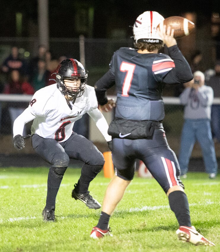 Nokomis' Garrett Engelman (#8) stalks Sullivan quarterback Cooper Christensen during the battle of the Redskins on Oct. 6 in Sullivan. Christensen scored a go-ahead touchdown with 1:25 to go in the game as Sullivan held on to their undefeated record with a 30-22 victory.