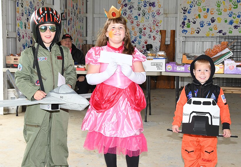 Winners from the left are Connor Budd of Litchfield as fighter pilot Maverick from Top Gun, Charley Herschelman of Hillsboro as Princess Peach from Super Mario Brothers and Landon Budd of Litchfield as an astronaut.