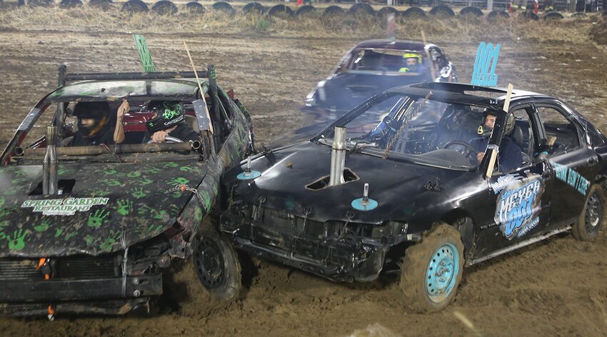 Eventual winner Cody Meyer, in the car on the right, puts a hit on a vehicle that disables the left front wheel during the compact stock class of the demolition derby at the Montgomery County Fair Fall Festival on Saturday night, Oct. 14, at the fairgrounds in Butler.
