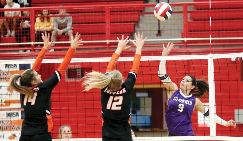 Litchfield senior Kendall Stewart tries to tip a shot over the top over Hillsboro blockers Addison Lowe (#14) and Ellie Miller (#12) during the regional semifinal game in Vandalia on Tuesday, Oct. 24. Despite the best efforts of the Panthers, who won game one 27-25, Hillsboro held off their intracounty rival 25-14, 25-18 in games two and three to advance to Thursday's regional championship game against Shelbyville.