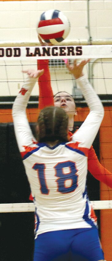 Lincolnwood's Ella Jenkins tips a shot over the net and past Mulberry Grove's Abby Emig during the Lancers' regional semifinal game in Raymond on Wednesday, Oct. 25. The Lancers beat the Aces 25-10, 25-16 to advance to Thursday's regional championship against Nokomis.