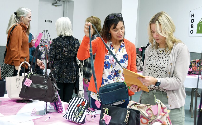 Friends Jennifer Anderson, at left, and Christine May, check out some of the purses in the silent auction at the 17th annual &ldquo;It&rsquo;s in the Bag&rdquo; purse auction to benefit the Hillsboro Area Health Foundation on Thursday evening, Nov. 2.