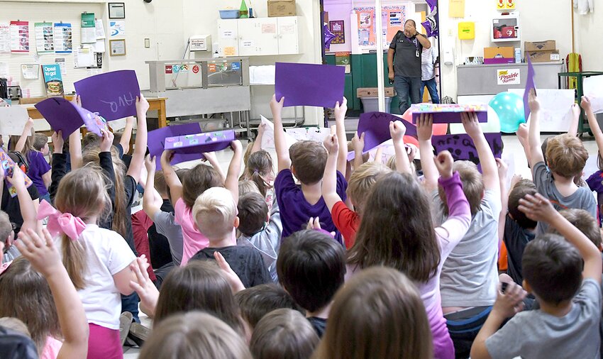 Kindergarten and first grade students at Madison Park Elementary School in Litchfield had a special surprise in store for Principal Adam Favre on Wednesday afternoon, Nov. 8. Favre has been named this year&rsquo;s Principal of the Year for the Kaskaskia Region of the Illinois Principals Association, and his students wanted to help him celebrate. They filled the school gym with posters and balloons as a special surprise for their beloved leader, pictured at back. Favre will be honored at a special reception on Thursday evening, Dec. 7, in Carlyle.
