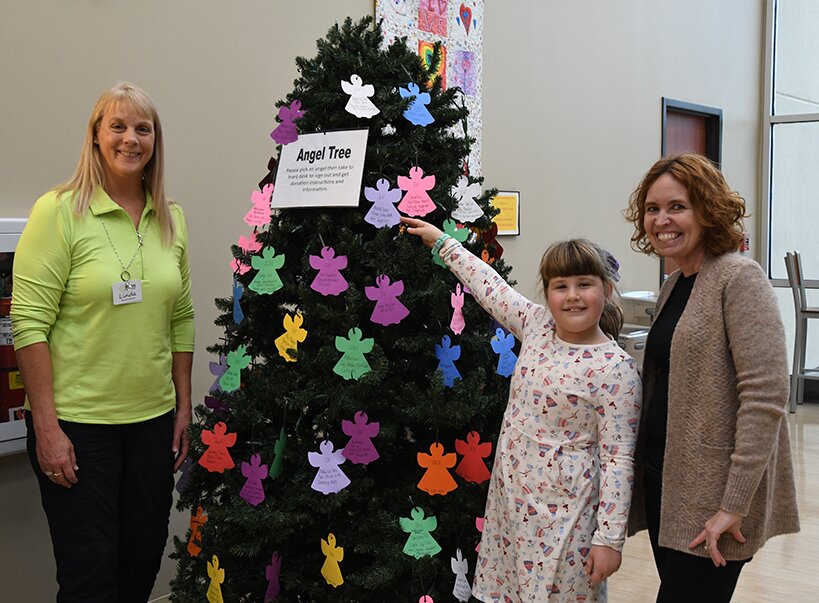 From the left are Fusion Executive Director Linda Weiss, Charley Herschelman and Angel Tree Chairman Melanie Sherer. Herschelman was the first to adopt angels off the tree this year.