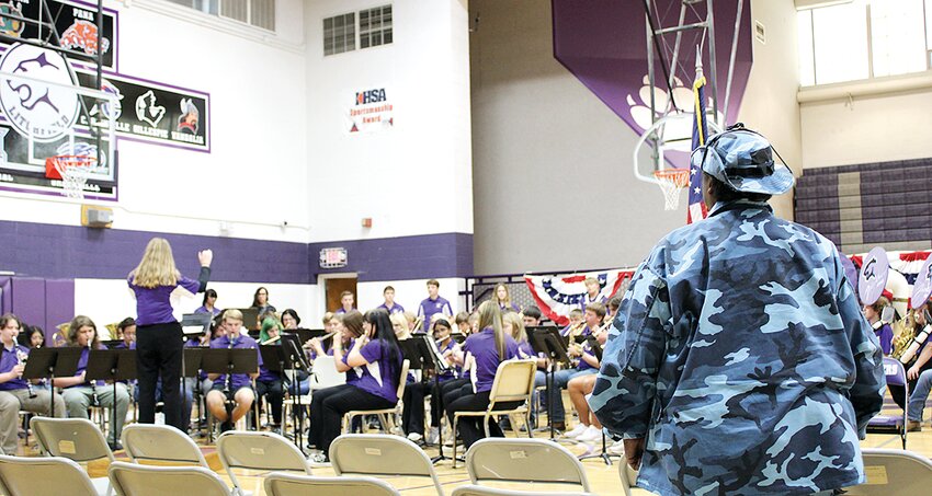 Pictured above, Yvonne Robinson of Litchfield stands as the Litchfield High School band plays the Armed Forces medley. Robinson served in the armed forces and was a part of operation Desert Storm. She is the mother of Litchfield High School track coach Anthony Robinson.