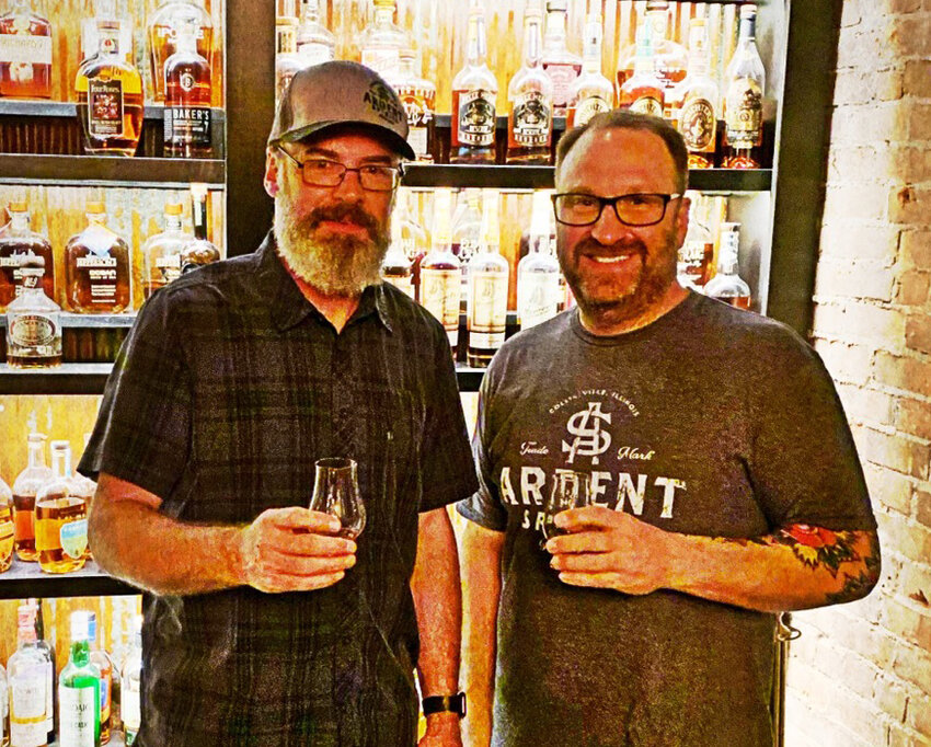 Derik Reiser of Old Herald Brewery and Distrillery in Collinsville, left, unveiled a new product at Opera House Brewing Company in Hillsboro with owner Tony Marcolini, right.