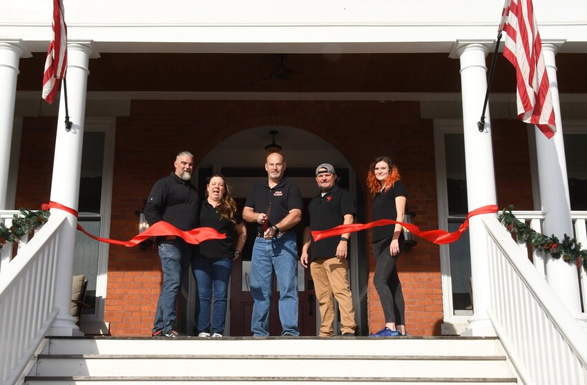 Helping to officially cut the ribbon, from the left are John and Kendra Wright, Hillsboro Mayor Don Downs, Tap Room General Manager Tim McConnell and Head Bartender Eve Meier.
