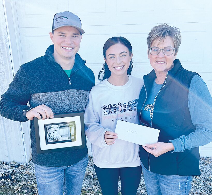 Newlyweds Cole and Olivia Grosenheider of Litchfield present a $1,500 check to Tina Hagemeier, president of the Montgomery County Breast Cancer Support Group. Proceeds were raised through a donation dance at their wedding reception in memory of Cole&rsquo;s mom, Alicia.