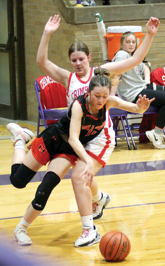 Hillsboro's Ella Greenwood draws a foul from Jacksonville's Jocelyn Smock as she tries to drive the baseline during the Lady Hiltoppers final game at the Taylorville Thanksgiving Tournament on Saturday, Nov. 25. Greenwood had nine points, including a pair of threes as Hillsboro picked up their first win of the season, 44-22 over the Crimsons.
