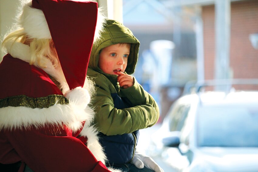 Ryker Weitekamp contemplates his options as he gets down to business with Santa Claus regarding the upcoming holiday season on Saturday, Nov. 25, in Farmersville.