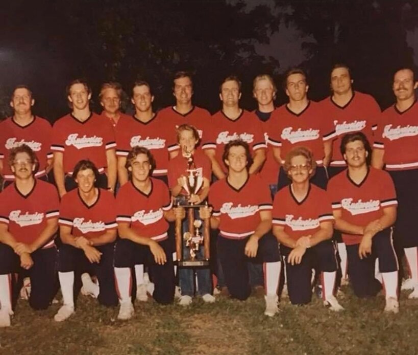 Pictured with the championship trophy,  in the front from the left is Curt Hagemeier, Kevin O&rsquo;Malley, Dan Clavin, batboy Mick Fieldbinder, Greg O&rsquo;Malley, Carl Fieldbinder and Brad Janssen. In the back row is John Crist, Tracy Epley, Dan Kinkelaar(representing Ronchetti Distributing), Barry Epley, Rick Brueckner, Rick Nelson, Roy Marquess, Monte Epley, Mike Havera and Karl Krumsiek.