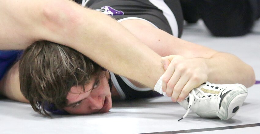 Litchfield's Tristan Staggs peers under the knee of a prone Dane Jiannoni of PORTA during their 190-pound match at the Litchfield duals on Saturday, Dec. 2. Staggs went on to pin Jiannoni at the 2:37 mark of the match, one of three wins on the day for the Litchfield sophomore. As a team, Litchfield went 3-2, with wins over Roxana, Pinckneyville and Carlinville.