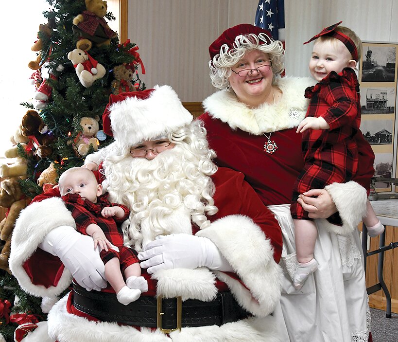 Pictured above, they greet sisters, Iverley Butler, age three months, and Serenity Butler, age one, who both got to meet Santa for the first time that morning.