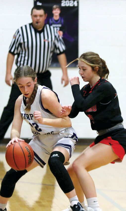 Hillsboro's Amya Greenwood closely guards Litchfield's Kyndal Law during the match-up between the two Montgomery County foes on Monday, Dec. 11. Law and company gave Hillsboro all they could handle for three quarters, before the Toppers used a 17-0 fourth quarter to pull out a 49-24 win.