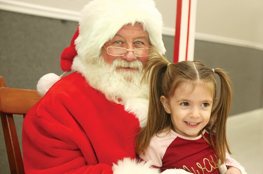 Olivia Plymale of Litchfield was one of hundreds of children to visit Santa Claus (as was her sister, Ileana) at stops all over the Litchfield Lighted Christmas event on Saturday, Dec. 16.  Olivia and Ileana whispered Christmas wishes to Santa at the event hosted by the Litchfield Park District at the Litchfield Community Center, where Professor Longhair made balloon animals, Litchfield McDonald&rsquo;s hosted a craft table, and there were plenty of snacks.  Santa also met with children at The Briar Rose earlier in the day, and at the Litchfield Moose Lodge later that evening after the Litchfield Lighted Christmas parade.