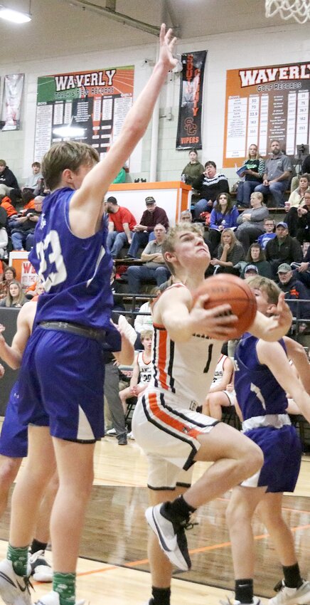 Lincolnwood's Cooper Poggenpohl (#1) tries to avoid the wingspan of North Greene's Luke Farris (#23) during the Lancers' consolation quarterfinal game at the Waverly Holiday Tournament on Wednesday, Dec. 27. The Lancers bounced back from Tuesday's loss to Auburn to beat the Spartans 44-32 as they advance to Thursday's consolation semifinal against Springfield Lutheran.