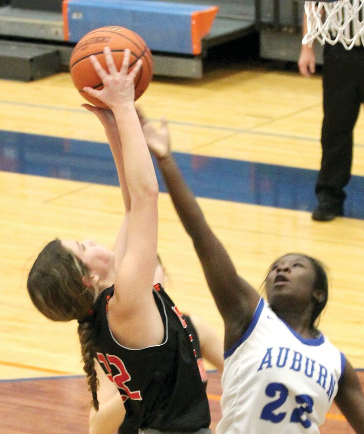 Hillsboro's #22, Tatum Christian, extends for a rebound over Auburn's #22, Karlissa Clark, during the Toppers' opening game at the Riverton Christmas Tournament on Thursday, Dec. 21. The Toppers beat the Trojans by one 47-46, one of their two wins at the tournament so far. Hillsboro will have the chance to go out on a win on as they play PORTA for third at 4:30 p.m. Thursday, Dec. 28.