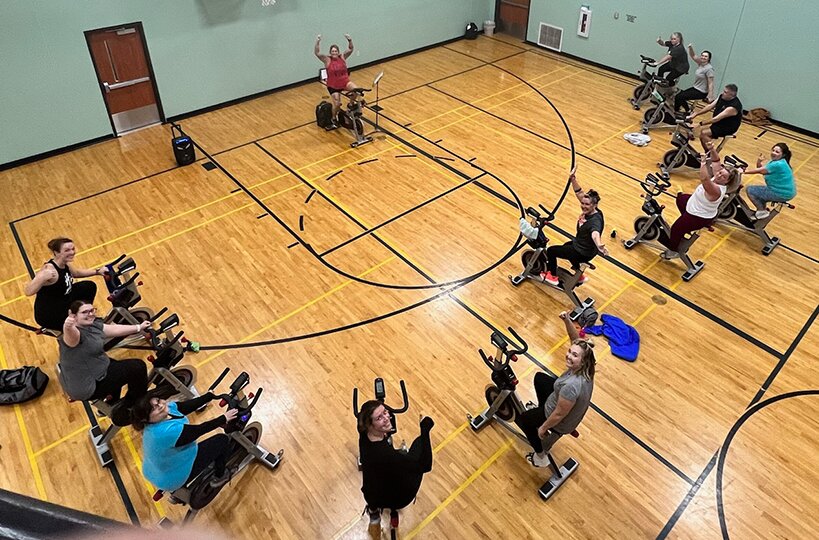 Fusion Fitness and Aquatics members enjoy a spin class in the facility's gym. Fusion kicked off its 15th annual Lighten Up for Montgomery County challenge this week.