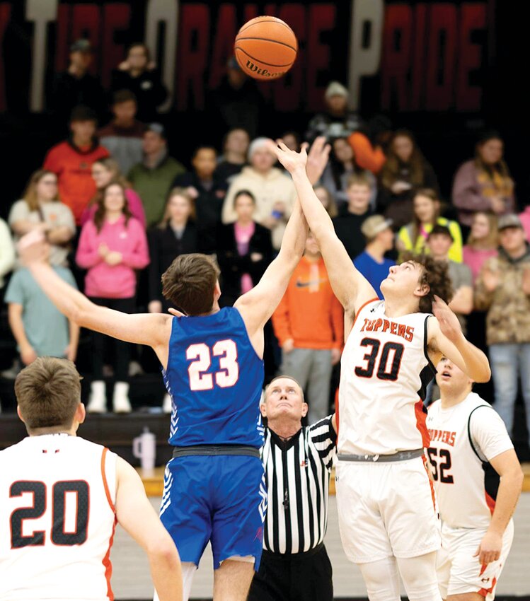 Hillsboro's Jace Stewart (#30) and Carlinville's Sawyer Smith (#23) go up for the tip to start the South Central Conference game in Hillsboro on Friday, Jan. 5. Stewart had 14 points in the Toppers' 50-47 victory over Carlinville, Hillsboro's second SCC win of the year.