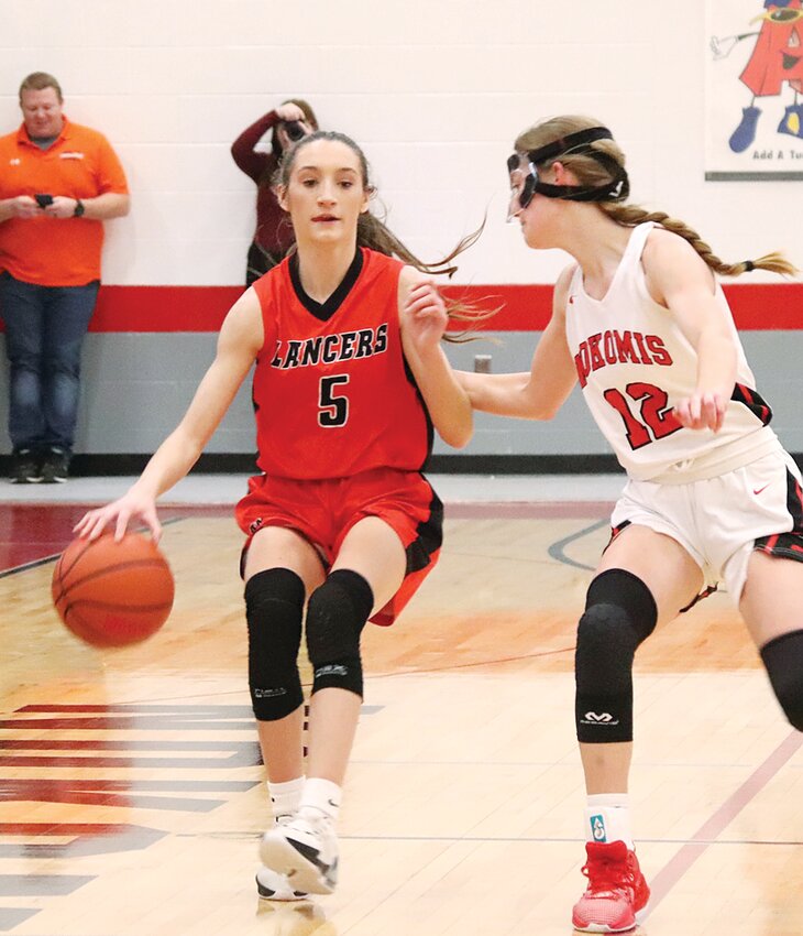 Nokomis' Natalie Brownback closely guards Lincolnwood's Sophia Foster during the Battle On The Blacktop on Friday, Jan. 5, in Nokomis. Brownback and the Redskins scored a 45-19 victory in the day game, which was played in front of students from both school districts.