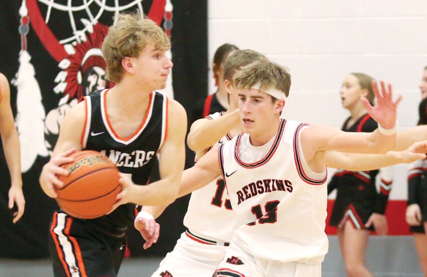 Nokomis' Mason Stauder, right, defends Donny Daugherty of Lincolnwood during the Battle On The Blacktop on Friday, Jan. 5, in front of sixth through 12th grade students from both schools. The students were treated to a show by their classmates as Nokomis scored a 47-46 victory over the Lancers thanks to a go-ahead basket by Reece Lohman in the final six seconds.