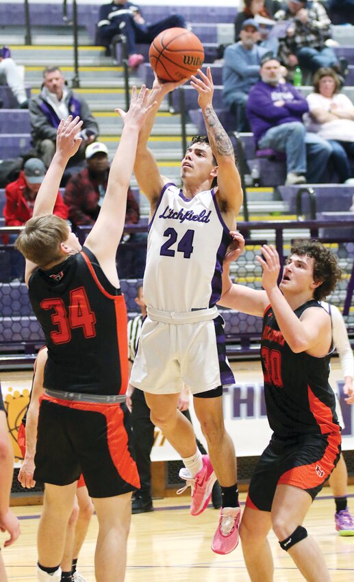 Sandwiched in between Hillsboro's Kamdin Civitate (#34) and Jace Stewart, Litchfield's Victor McGill rises up for two of his 24 points in the Panthers' 63-32 victory over the Hiltoppers in both teams' first game at the Rick McGraw Memorial Invitational on Jan. 13. McGill nailed a three-pointer to start the game, becoming the 17th member of the program's 1,000 point club.