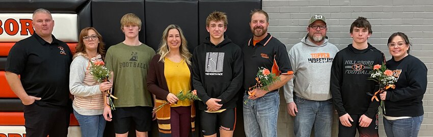 The three senior members of the Hillsboro High School wrestling team were honored, along with their parents on Wednesday, Jan. 17, before the Toppers&rsquo; match with Highland. From the left are Zander Wells, with parents Mike and Haley Wells; Ian Anderson, with parents Jacqui Anderson and Adam Anderson; and Treyton Kuhl, with parents Todd and Rachel Kuhl.