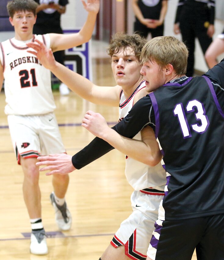 Litchfield's Nathan Schaake (#13) defends Drake Taylor of Nokomis during the seventh place game of the Rick McGraw Memorial Invitational on Saturday, Jan. 20, in Litchfield. Schaake and the Panthers snapped a 15-year drought against the Redskins, winning 47-26 for their first victory over Nokomis since Jan. 15, 2008.