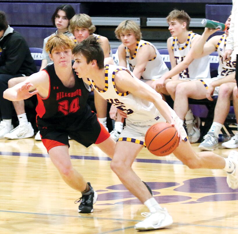 Hillsboro's Mark Mattson (#24) guards Dillon Clark (#5) of Taylorville during the ninth place game at the Rick McGraw Memorial Invitational in Litchfield on Saturday, Jan. 20. The Tornadoes led 23-10 after the first quarter, then held on for a 75-62 victory over Hillsboro to take ninth.