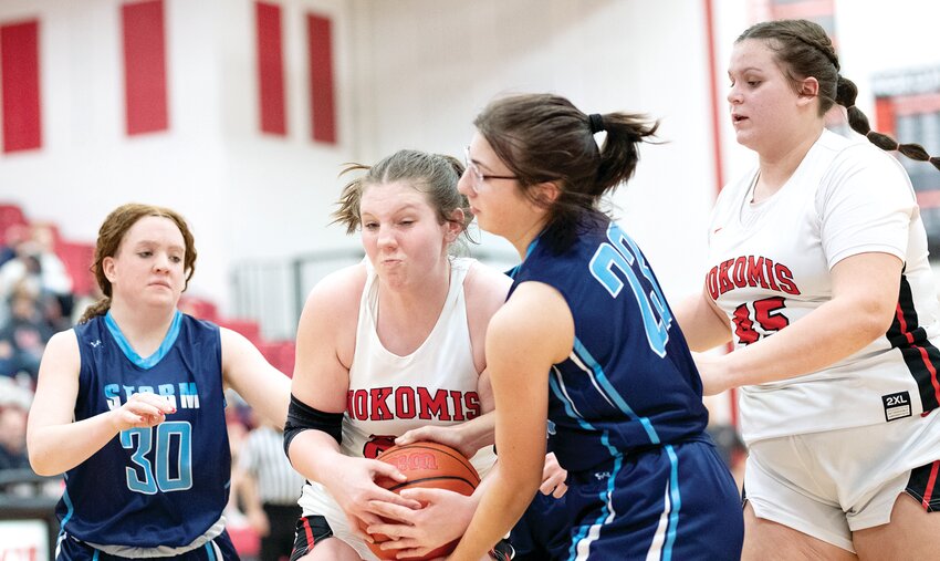 Nokomis' Kinley Stolte and Sangamon Valley's Sophia Caceres wrestle for possession of a rebound as their teammates Allison Closs (#30) and Alivia Sabol (#45) wait for the result. Stolte and Sabol were two of the 10 Nokomis players to score in the 61-10 victory over Sangamon Valley, which guaranteed Nokomis at least a share of the MSM Conference title for the third time in four years.