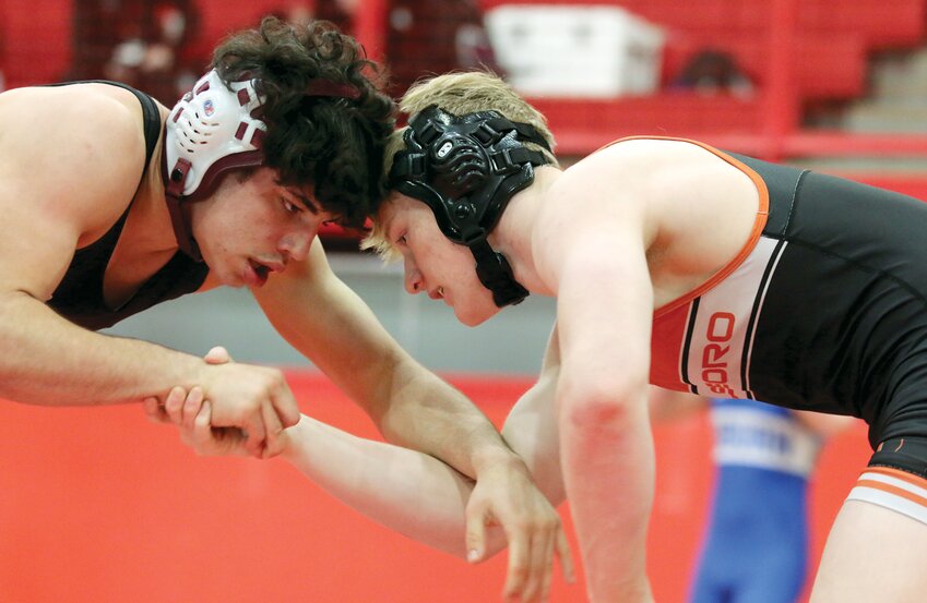 Hillsboro's Zander Wells (left) locks up with Tiffin Kouzoukas of Benton during their quarterfinal match at the Vandalia Sectional on Friday, Feb. 9. Wells defeated Kouzoukas in an 11-5 decision one of three wins on the weekend as the senior went on to finish third and qualify for the IHSA Class 1A State Tournament for the first time.