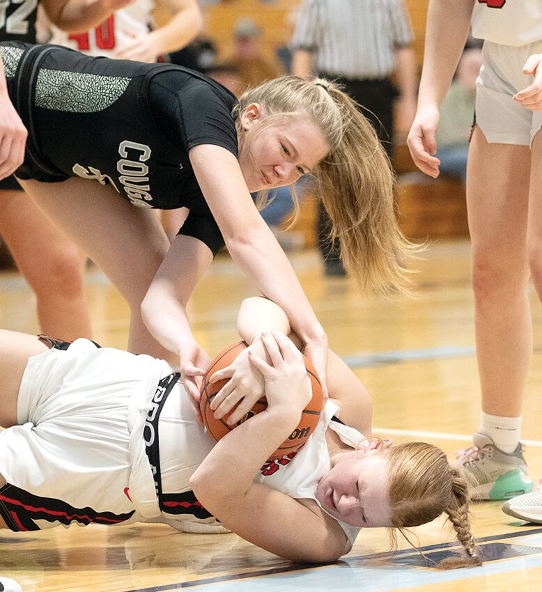 West Central's Baylee Littig tries to wrestle possession away from Nokomis' Cloey Dirks during the regional semifinal game in Concord on Tuesday, Feb. 13. Dirks had a team-high 11 points for the Lady Redskins, but a tough second quarter stretch that carried over into the third proved costly for Nokomis, whose season came to an end with a 53-37 loss to the Cougars.