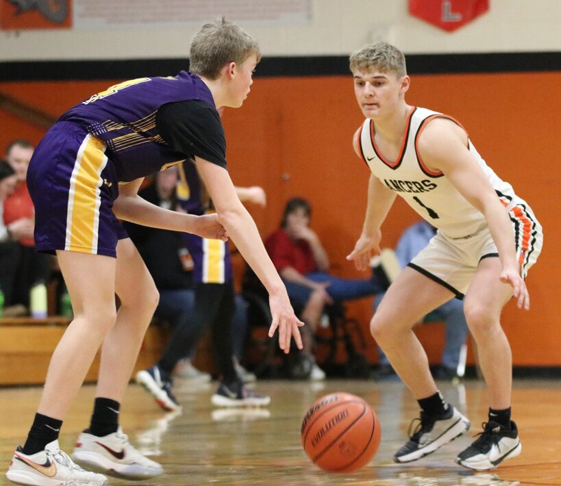 Cooper Poggenpohl (right) and the Lincolnwood defense held Mt. Olive to just 29 points on Monday, Feb. 19, as the Lancers knocked off the Wildcats 58-29 to advance to Wednesday's regional semfinal against Carrollton. Lincolnwood has held a team under 30 points for the fourth time this season and for the second straight game against Mt. Olive, who they beat 59-16 in December.