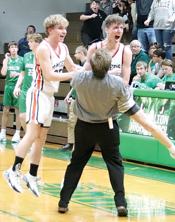 Lincolnwood Head Coach Matt Millburg celebrates with Donny Daugherty (left) and Tucker Armentrout after Armentrout hit an off-balance three at the end of regulation to tie Carrollton at 39 in the regional semifinal on the Hawks' home floor on Feb. 21. The Hawks managed to survive the miracle, though, beating the Lancers in triple overtime 50-47.