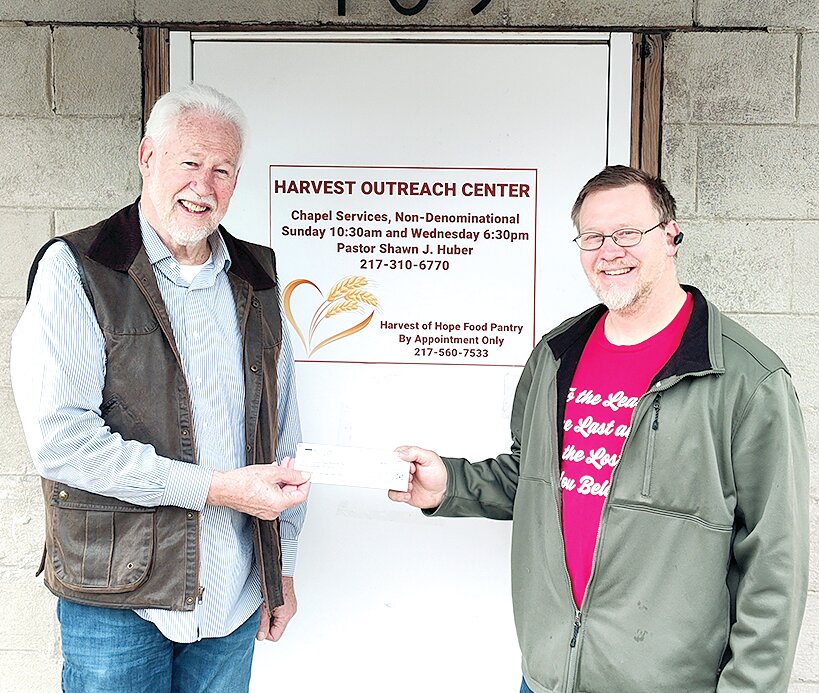 The Hillsboro Methodist Church hosted a pancake and sausage breakfast fundraiser on Saturday, Feb. 17, raising funds for the Harvest of Hope food pantry. Pictured above, pastor Steve Lawton presents a check for $2475 to Shawn Huber, pastor of the Harvest Outreach Center.  The food pantry is located at 109 S. Hamilton St. in Hillsboro, and available by appointment at 217-560-7533.