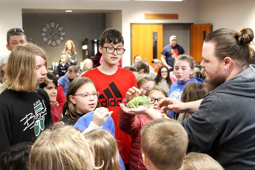 Pictured above, Samuel Rhodes of Litchfield Zoo holds out a chameleon for thrilled children to pet at Litchfield Library on Wednesday, Feb. 28.