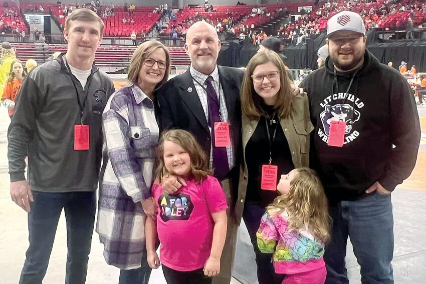 Litchfield's Dan Newkirk was the grand marshal for the IESA Parade of Champions at the state wrestling championships in Dekalb on Saturday, March 9. Pictured with Newkirk are his son Seth, wife Amy, daughter and son-in-llaw Betzy and Jake Szerletich and his granddaughters, Emma and Chloe Szerletich.