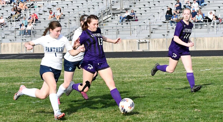Litchfield's Daphney Hartel (#13) splits a pair of Jerseyville defenders en route to her first goal of the season during the Purple Panthers' season opener on Wednesday, March 13, at Lloyd Hill Field. Hartel and Madi Mix (#14) had a goal apiece in Litchfield's 4-0 win, with Chloe Law accounting for the other two scores.