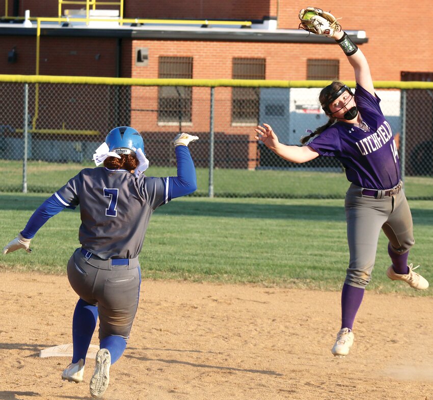 Litchfield-Mt. Olive's Lili Readenour elevates to snag the throw from the outfield as Marquette's Jayla Dickson closes in on second base with a double. Dickson was 4-for-4 with four runs scored for the Explorers and Readenour went 3-for-3 with three runs scored for the Panthers as Litchfield won a slugfest on Thursday, March 21, by a 16-9 final score.