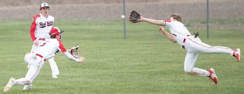 Nokomis' Kannon Jonas (left) and Brenton Lyons (right) go all out for a short fly ball during the Redskins' home game against Taylorville on Monday, March 25. The pair ended up colliding on the play, forcing Lyons to miss the rest of the game. Before then, the senior had two hits and scored a run as the Redskins defeated Taylorville 11-1.