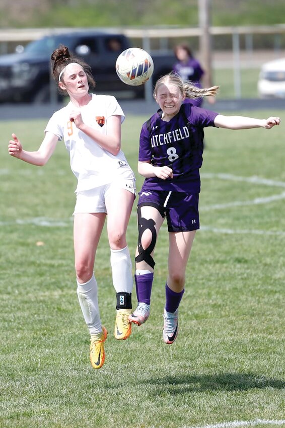 Hillsboro's Kearstynn Davis (left) and Litchfield's Chloe Law (right) go up for a 50/50 ball during the third place game at the Panther Classic in Litchfield on Saturday, March 30. After losing to Hillsboro twice last year, the Lady Panthers scored a 2-1 victory over the Toppers, with Law scoring the go-ahead goal in the second half.