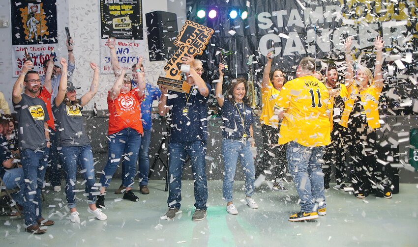 The confetti flew as Team Um-Believable was crowned champions at the 13th Stamp Out Cancer event, held Saturday, April 6, at The Event Center of Montgomery County in Taylor Springs. Pictured above, Zach Wygal of Stamp Out Cancer, at right, presents the trophy to Denny and Tina Umberger of Nokomis for raising over $63,000 for the Montgomery County Cancer Association. This year&rsquo;s four fundraising teams raised over $136,000 for the MCCA, bringing the Stamp Out Cancer total to over $1 million donated since its inception.