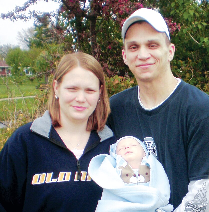 Michael and his wife, Amanda, proudly pose for this 2011 photo with their newborn son, Grant.  Little did they know of the devastating events that would arise to change their lives forever. Local residents have joined forces to help raise funds to get Michael an accessible van for Grant.