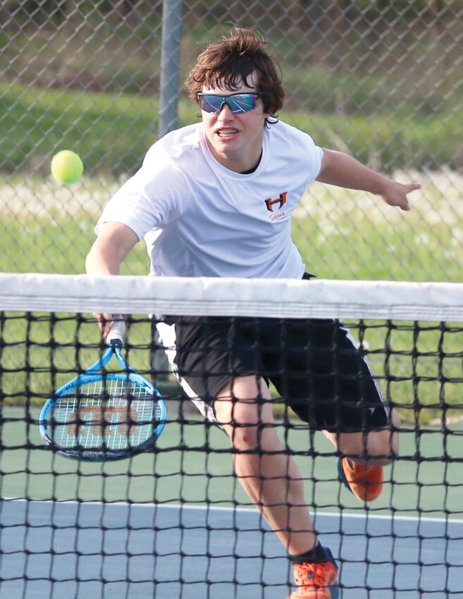 Hillsboro's Quinn Hunt returns a shot during the Toppers' match with Rochester on Monday, April 15. While things didn't go great against the visiting Rockets (Rochester won 9-0), Hillsboro did better the following day as they beat Roxana 7-2, with Hunt picking up a win in singles and doubles with partner Mark Mattson.