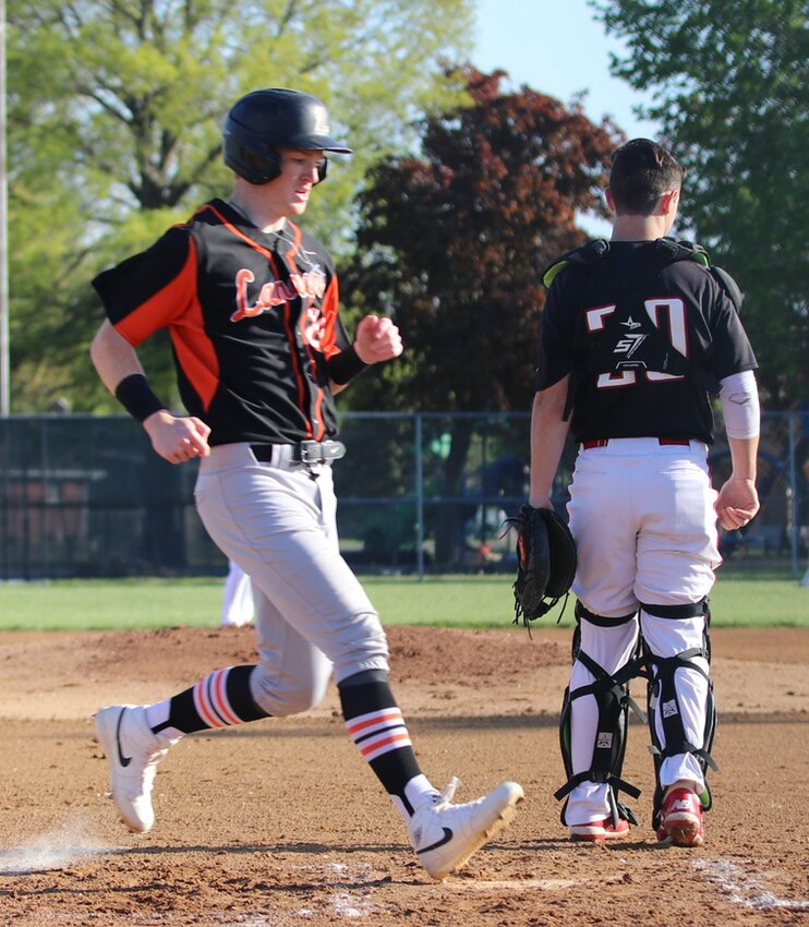 Lincolnwood's Lance Weitekamp crosses home behind Nokomis catcher Nolan Herpstreith during the MSM/Montgomery County tilt on April 24. Weitekamp's run helped the Lancers take an early 3-0 lead, but Nokomis came back and held on for a 6-5 victory over the home team.